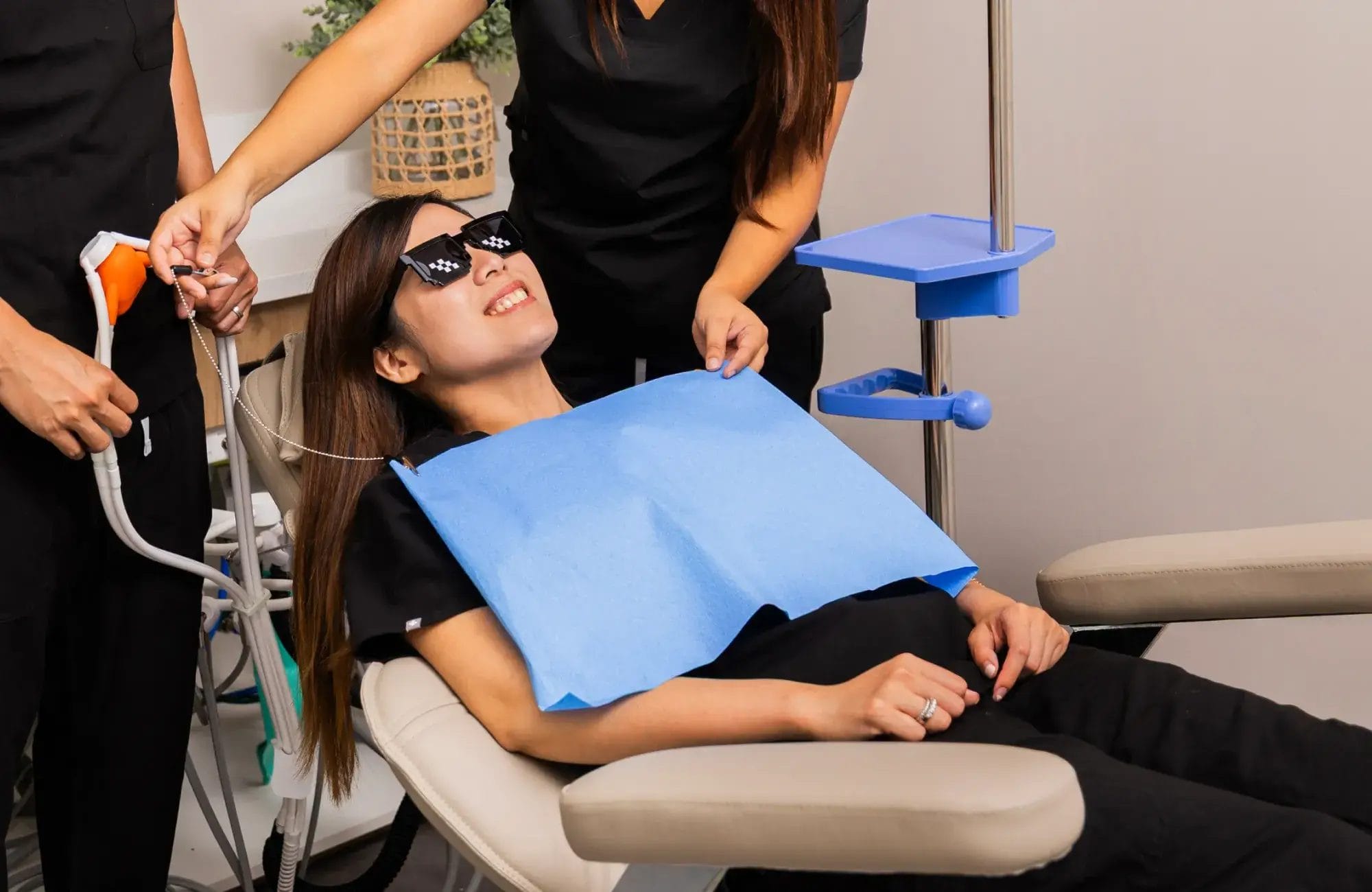 Aster Smiles comfort-focused dentistry: dentist and assistant ensuring a patient feels at ease during treatment.